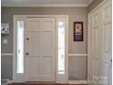Welcoming foyer featuring neutral paint, white trim and a decorative front door with sidelights at 1525 Oakridge Dr, Salisbury, NC 28146