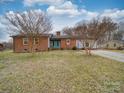 Charming single-story home with brick and vinyl siding and a well-maintained front lawn at 1525 Oakridge Dr, Salisbury, NC 28146