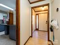 Welcoming entryway with classic white door, wood trim, and practical storage hooks at 1590 Daybreak Ridge Rd, Kannapolis, NC 28081