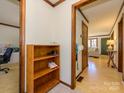 Cozy hallway showcasing hardwood floors, wood trim, with views into a study and living room at 1590 Daybreak Ridge Rd, Kannapolis, NC 28081