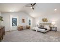 A luxurious main bedroom with high ceilings, neutral tones, and sitting area offers a serene retreat at 1608 Breezewood Dr, Charlotte, NC 28262