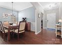 Dining room with hardwood floors, view to entry, and a modern chandelier at 1630 Sassafras Ct, Fort Mill, SC 29715