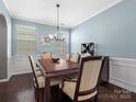 Formal dining room with hardwood floors, elegant chandelier, and wainscoting at 1630 Sassafras Ct, Fort Mill, SC 29715