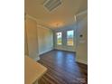 Bright dining room with hardwood floors and natural light from two windows at 2039 Clarksdale St # 32, Charlotte, NC 28206