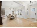 Bright dining room featuring stylish chandelier, hardwood floors, and ample natural light at 2127 Nims Village Dr, Fort Mill, SC 29715