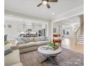 Spacious living room with modern decor, hardwood floors, and open layout to the kitchen at 2127 Nims Village Dr, Fort Mill, SC 29715