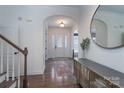 Elegant foyer with hardwood floors, wainscoting, large round mirror and lots of light at 228 Black Mountain Dr, Fort Mill, SC 29708