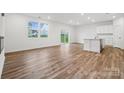 Open living space with wood floors, a large window, and sliding glass door with an eat in kitchen area at 295 Bezelle Ave, York, SC 29745