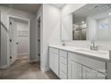 Modern bathroom with double vanity, white cabinets and a large mirror with lots of counter space at 302 Bezelle Ave, York, SC 29745