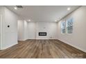 Open-concept living room featuring an electric fireplace, recessed lights and wood flooring at 302 Bezelle Ave, York, SC 29745