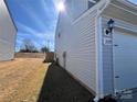 The side exterior of the house shows the vinyl siding and well-maintained lawn at 329 Aniston Ln, Shelby, NC 28152