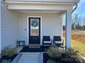 Charming front porch featuring seating area, tasteful decor, and welcoming entrance at 329 Aniston Ln, Shelby, NC 28152