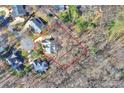 Aerial view of a home and its surrounding land in a leafy neighborhood, bordered by a red outline at 4219 Kronos Pl, Charlotte, NC 28210