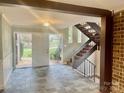 Foyer featuring slate tile, staircase with iron railings, and natural light at 4220 Honeysuckle Rd, Rock Hill, SC 29732