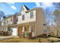 Charming townhome featuring a covered porch, one car garage and neutral-toned siding at 471 Doughton Ln, Charlotte, NC 28217