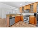 Well-lit kitchen features wooden cabinetry, stainless steel appliances, and a granite countertop at 471 Doughton Ln, Charlotte, NC 28217