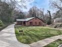 Beautiful brick home with a neatly kept lawn and a mailbox at the end of the long driveway at 48 Washington Se Ln, Concord, NC 28025