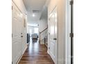 Hallway with hardwood floors leads to the living area and staircase at 5212 Spanish Ivy Ln, Indian Land, SC 29707