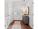 Inviting entryway with hardwood floors, a decorative mirror, and neutral paint at 6449 Silver Star Ln, Charlotte, NC 28210
