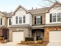 Two-story townhome with brick and siding, a front-entry garage, and groomed front yard at 6449 Silver Star Ln, Charlotte, NC 28210