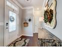 Welcoming foyer features a decorative mirror and console table with a beautiful wreath and coat rack at 7035 Walnut Branch Ln, Charlotte, NC 28277