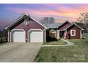 Charming single-story home with two-car garage, well-maintained lawn, and inviting walkway at 7102 Lanark Ct, Charlotte, NC 28217