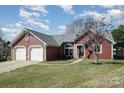 Attractive single Gathering home with attached two car garage and well maintained front yard at 7102 Lanark Ct, Charlotte, NC 28217