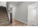 Bright hallway with hardwood floors, staircase with dark wood accents, and doors leading to other rooms at 7113 Brookview Ln, Sherrills Ford, NC 28673