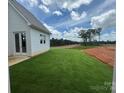 Expansive backyard with a manicured lawn, offering picturesque views of the surrounding greenery at 7441 Fighting Creek Rd # 30, Sherrills Ford, NC 28673