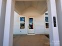 Inviting covered front porch with white columns, showcasing the home's entrance and details at 7441 Fighting Creek Rd # 30, Sherrills Ford, NC 28673