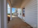 A covered front porch with white columns, with view of neighboring home at 7441 Fighting Creek Rd # 30, Sherrills Ford, NC 28673
