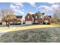 Traditional two-story brick home with a spacious lawn located in a residential neighborhood at 8013 Pelorus Ln, Charlotte, NC 28269