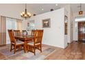 Elegant dining room featuring wood table, chairs, decorative lighting and hardwood floors at 9130 Twilight Hill Ct, Charlotte, NC 28277