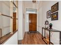 Inviting entryway with wood floors, console table and wall mirror, setting a stylish tone at 9130 Twilight Hill Ct, Charlotte, NC 28277