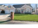 Charming home featuring a lush green lawn, well-maintained landscaping, and an inviting front entrance at 9130 Twilight Hill Ct, Charlotte, NC 28277