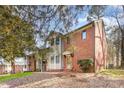 Brick and siding townhome with mature landscaping and mulched front yard at 1035 Nw Wexford Pl # D3, Concord, NC 28027