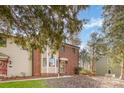 Townhome exterior with brick and siding, surrounded by mature trees and landscaping at 1035 Nw Wexford Pl # D3, Concord, NC 28027