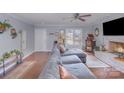 Inviting living room with hardwood floors, a brick fireplace, and a large comfy gray sectional sofa at 110 Weeping Willow Way, Gastonia, NC 28052