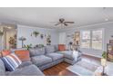 Inviting living room with a large gray sectional sofa, hardwood floors, and neutral paint, creating a relaxing atmosphere at 110 Weeping Willow Way, Gastonia, NC 28052