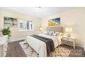 Cozy bedroom showcasing a queen bed, soft lighting, and stylish decor at 1323 Queens Rd # 218, Charlotte, NC 28207