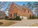 Brick home with a three car garage and paved driveway at 16506 Doves Canyon Ln, Charlotte, NC 28278