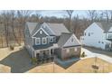 An aerial view of a distinguished home with brick and siding, complemented by a pristine lawn at 17215 Monocacy Blvd, Huntersville, NC 28078