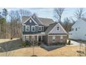 Beautiful two-story home boasting gray siding, brick accents, and manicured landscaping at 17215 Monocacy Blvd, Huntersville, NC 28078