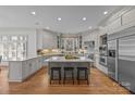 Modern kitchen with an oversized island, stainless steel appliances, and custom cabinets at 18302 Town Harbour Rd, Cornelius, NC 28031