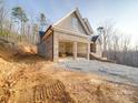 View of the new construction brick home showcasing the attached two-car garage and unfinished lawn at 240 Mark Ryan Ln, Dallas, NC 28034