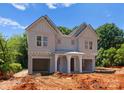 New construction duplex featuring light grey siding, a covered entrance, and two attached garages at 3627 Rogers St, Charlotte, NC 28208