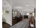 Open concept dining room with hardwood floors, elegant chandelier, and seamless transition into the kitchen at 393 Brannon Meadows Dr, York, SC 29745