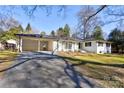 View of a bright one-story home featuring a convenient carport and a well-maintained driveway at 435 Caldwell Se Dr, Concord, NC 28025