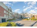 Condominium community featuring manicured landscaping, covered parking, and beautiful brick buildings at 5425 Closeburn Rd # 105, Charlotte, NC 28210