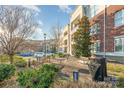 Beautiful condominium community with lush landscaping, benches, and walkways at 5425 Closeburn Rd # 105, Charlotte, NC 28210